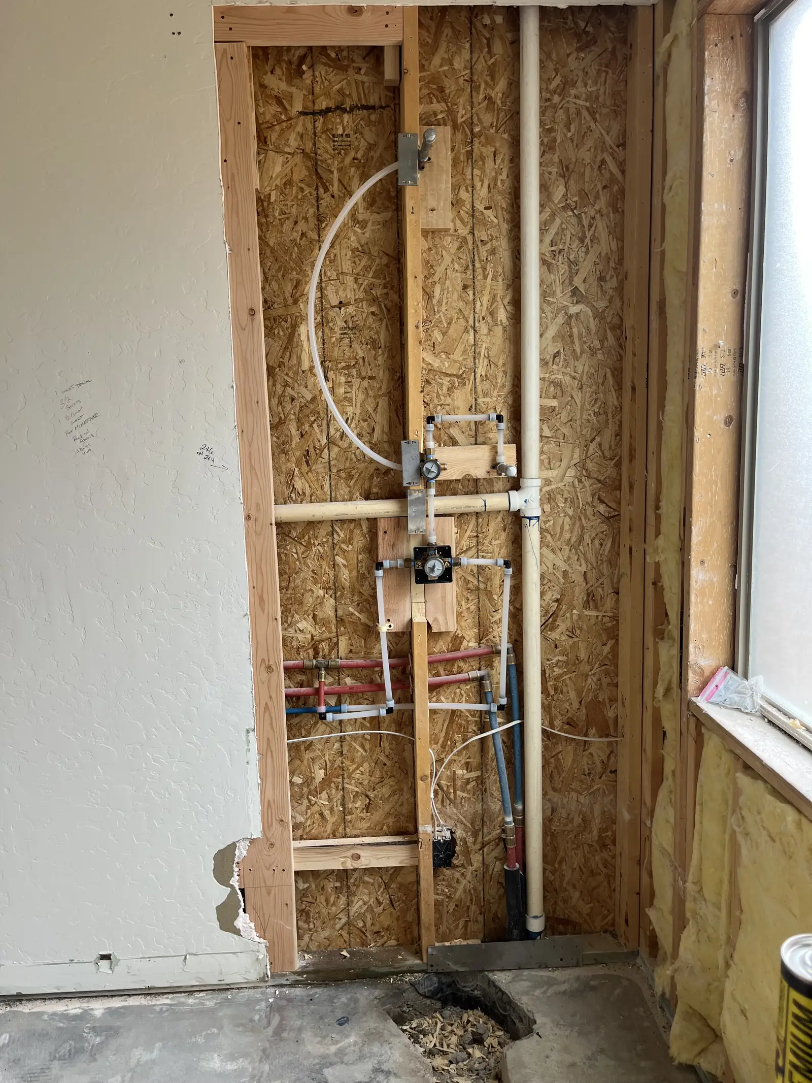 Shower wall opened up to the plumbing